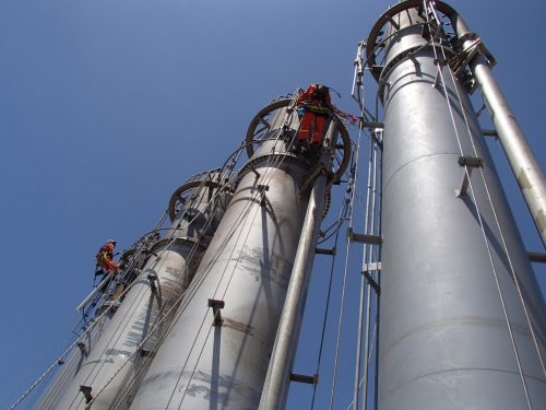 Two vertech IRATA rope access technicians climb separate flares as part of a flare testing service.