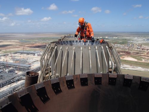 A vertech technician is carrying out testing on top of a flare.