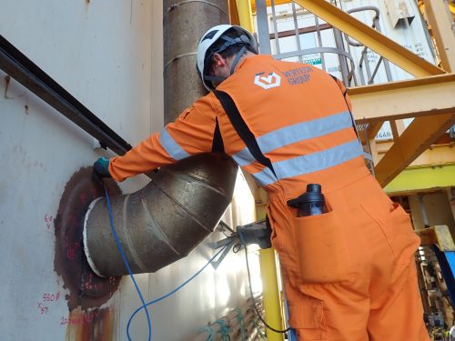 A vertech Non-destructive testing (NDT) technician conducting ultrasonic thickness (UT) measurements on an offshore asset.