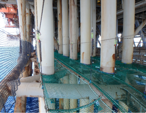 This image shows the tension netting installed to access the risers and conductors on an offshore platform for inspection, NDT, and remediation.