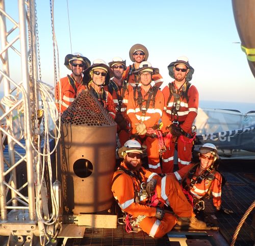 A team photo at the top of the Ichthys Venturer FPSO for Inpex. The team is made up of high performing IRATA rope access riggers and rope access mechanical fitters.