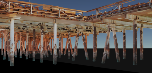 This image showcases a 3D visualisation of the underside of an offshore oil platform. It depicts the intricate structure of support beams and legs, which appear weathered and corroded, highlighting the harsh conditions of the marine environment. The image has been rendered with realistic textures and shadows, providing a detailed view of the platform's architecture from below. This perspective allows for a close inspection of the condition of the materials and the construction elements, which are essential for maintenance and safety checks in the real world. The dark backdrop emphasises the isolation of the structure in the open sea.