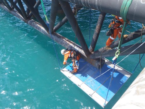 An IRATA rope access team using a deck system as a work position platform on the KGP Birth 3 project.