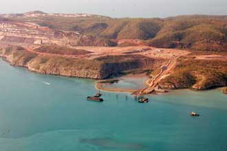 A photograph of a semi-bird's eye view of Koolan Island, mining operations, and some ships at sea can be seen. Taken in the early 2000s.