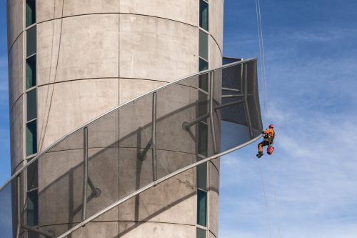 An IRATA rope access inspector is conducting steelwork and concrete inspections.