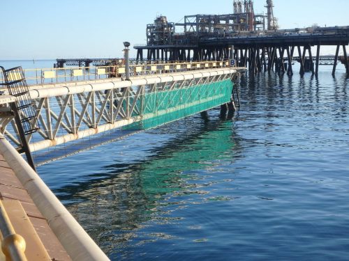 A Vertech engineered deck with netting encapsulation installed on an LNG jetty by rope access tradesmen for fabric maintenance and inspection purposes.