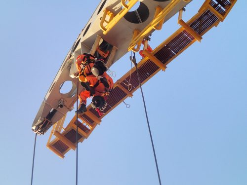 A vertech API crane inspector conducting rope access inspection on an offshore pedestal mounted crane