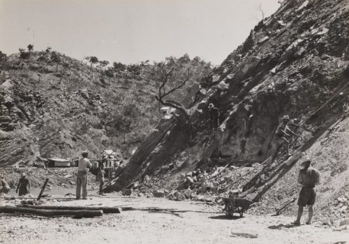 A black and white image of workers gathered in one of the first mining pits dug on Koolan Island, taken in the 1930s.